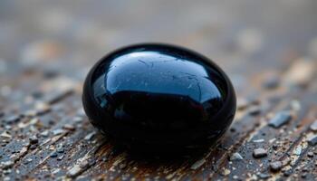 close up view of a polished jet gemstone with solid black color and smooth luster. photo