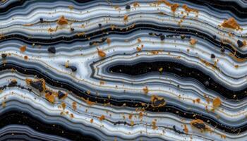 close up view of a polished onyx slab with black body and clean white bands. photo