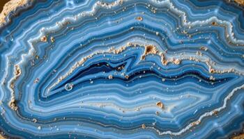 close up view of a polished blue lace agate showing gentle white waves across light blue stone. photo