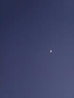 Capture the night sky a crescent moon shining in the dark blue sky photography and astronomy image photo