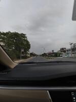 Driving view road trip scenic route car interior dashboard travel destination cloudy sky journey adventure photo