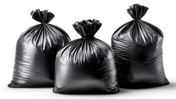 Black garbage bags ready for disposal. Three black garbage bags are neatly tied and prepared for collection in an indoor setting, showcasing waste management. photo