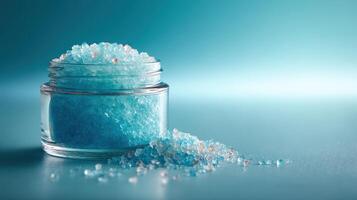 Bath salts in a glass container showcasing a vibrant blue color on a soft textured surface photo