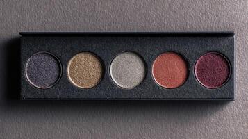Palette with empty pans awaiting vibrant eye shadows for artistic makeup designs and creative expression in a professional setting photo