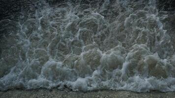 A close up of a wave crashing into the water photo