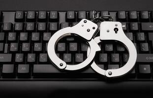 Handcuffs on a keyboard background photo
