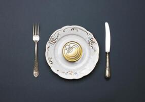 Tin can on a plate, with cutlery photo