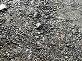 Detailed close up view on pebbles and stones on a gravel ground texture in high resolution photo