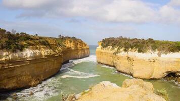 Loch Ard Gorge's stunning cliffs and turquoise waters under bright daylight. Captured in Port Campbell, Australia, showcasing natural beauty video