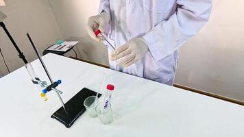 Scientist conducts a bromothymol blue experiment in a lab setting, showcasing chemical reactions and color changes video