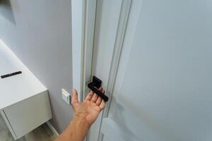 A person easily opens a door with their hand, highlighting the simple and effective way we interact with doors when entering and exiting different spaces in our daily lives photo