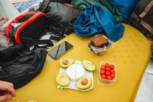 Enjoy outdoor dining with fresh avocados and cheese during an exciting camping adventure. Hike, relax, and savor snacks around the campfire for a memorable time with friends under the stars photo