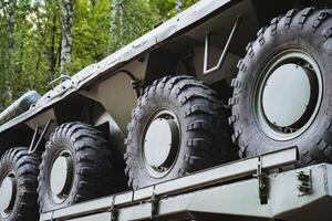 A large collection of tires can be seen positioned on the back of a vehicle, ready for use or transport, showcasing the essential components of land vehicles and modes of transportation photo