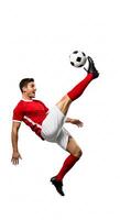 A man in red is kicking a soccer ball photo