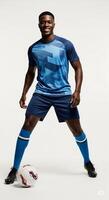 A man in blue soccer uniform posing with a soccer ball photo