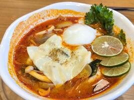 Bowl of Spicy Tom Yum Soup with Egg photo