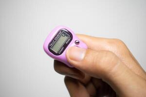 Counting with a digital finger counter. photo