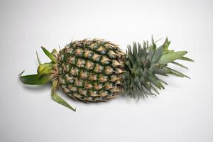 Fresh whole pineapple lies on a white background. photo