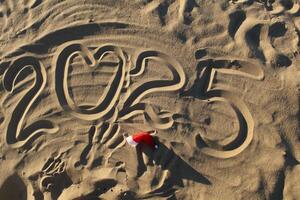 2025 New Year Written in the Sand with the Heart Symbol photo