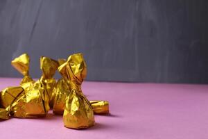 Candy on a pink background. The process of wrapping candies. Homemade sweets photo