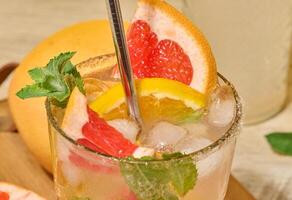 Citrus cocktail with mint and fruit photo