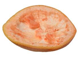 Empty half of grapefruit peel, with pulp remaining, isolated on background. photo