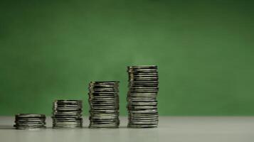 Stacked coins ascending order on green background from Low to High, representing economic recovery, financial growth, increasing savings, profitable investments photo