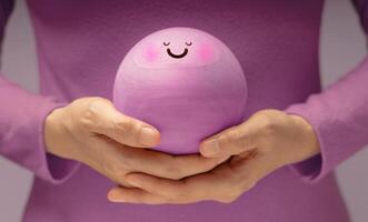 Hands gently holding Smiling Circle face. Mental health, emotional balance,inner peace through meditation and mindfulness. symbolizing good mental and self-awareness photo