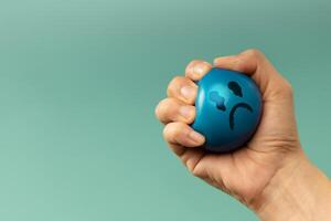 Hand Squeezing a ball used for emotional control and mental health practice, helping Stressed person reduce tension and improve mood photo