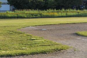 a close up of third base on diamond two in the park at dawn photo