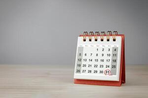 Date 31 is circled in red with the word Retire on small desk calendar. Retirement planning concept, with copy space. photo