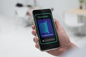 Security system with facial recognition, Face ID. Man unlocks smartphone with biometric identification scan, personal verification. photo