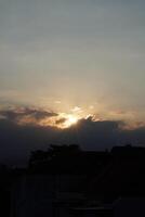 Afternoon sunlight in a city with the sky turning dark photo