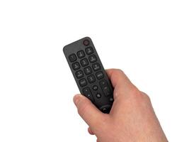 White male hand on white background presses buttons on TV remote control, TV channels with remote control, for banners, for TV advertising. Copy space, flay lay, top view. photo