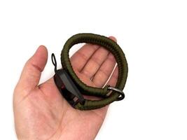 Green camera strap in the form of a rope on a white background. copy space, top view photo