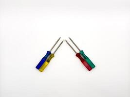 Four small colored plastic screwdrivers on a white background. copy space, flay lay photo