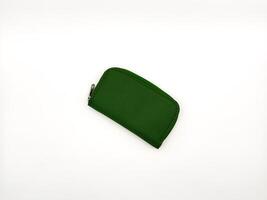 Small green fabric wallet with zipper on white background. copy space, flay lay photo