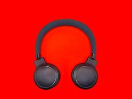 Dark green big headphones on a plain bright red background for banners, for advertising photo