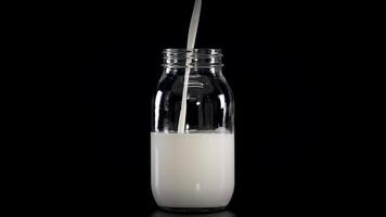 Milk being poured into jars with straws video