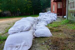 Sandbags stacked near house for flooding protec photo