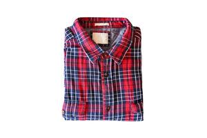 Red checkered flannel shirt folded on a white isolated background photo