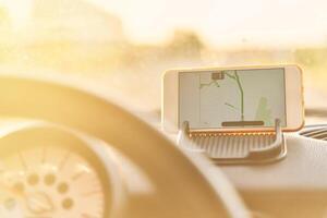 The map on the phone in the background of the dashboard. photo
