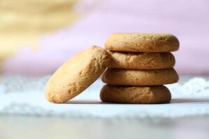 A stack of cookies on a white table photo