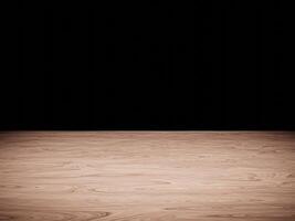 Natural wood table top illuminated by soft light, contrasting with a black background. photo