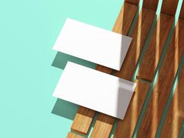 Minimalistic business card resting on a wooden surface with shadows. photo