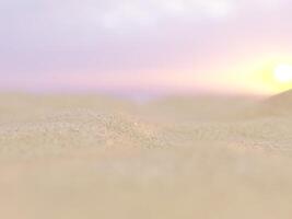 Sandy beach dunes with blurred ocean waves and a clear sky in the background. photo