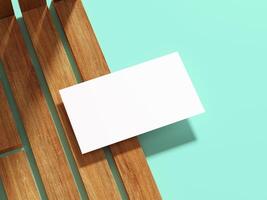 A simple business card on a wooden plank with a cool flat backdrop. photo