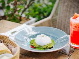 Avocado dish with poached egg photo