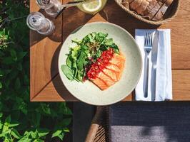 Salmon salad with greens and tomatoes photo