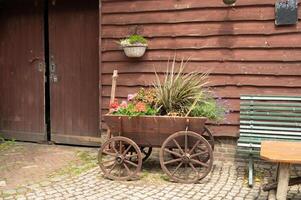 Rustic wooden cart with colorful flowers by vintage barn photo